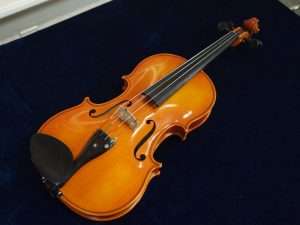 Nahaufnahme einer Geige auf dunklem Hintergrund.